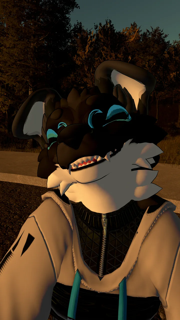 Mojar’s smiling VRChat avatar, with dark fur, teal markings and a cream hoodie